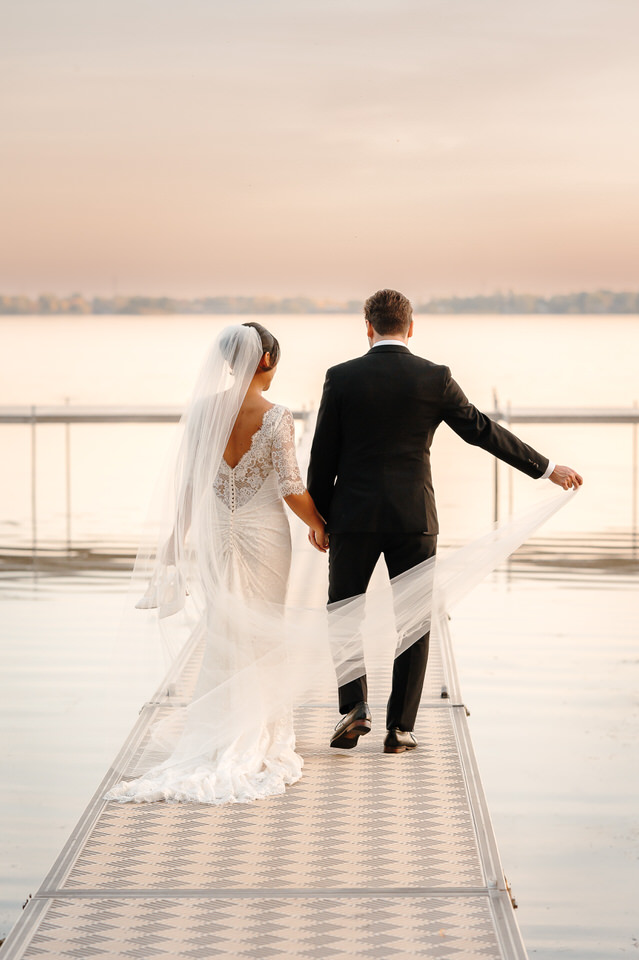 Wedding couple portrait on the dock at Château Vaudreuil in soft autumn light