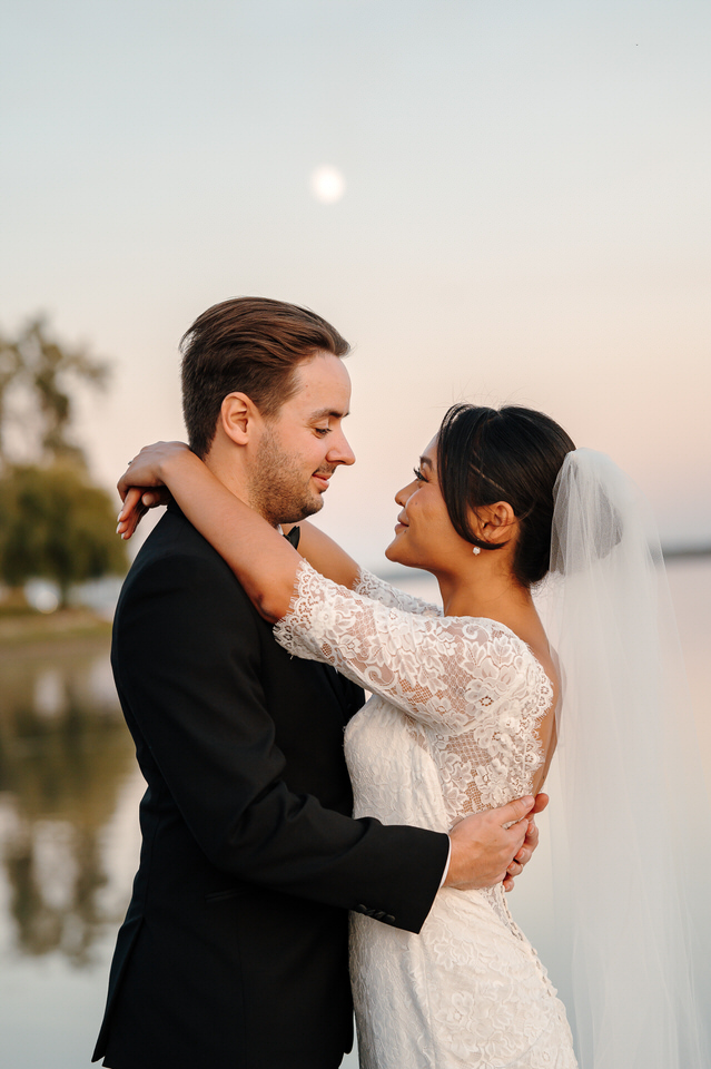 Wedding couple portrait on the dock at Château Vaudreuil in soft autumn light